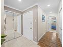 Inviting hallway featuring neutral paint, mirrored closet, and doorways to other rooms at 213 Fernwood Cir # 213, Seminole, FL 33777