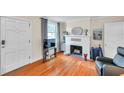 Cozy living room with hardwood floors, fireplace, and natural light at 320 Broadway, Dunedin, FL 34698