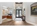 Welcoming foyer boasting hardwood floors, stylish lighting, and an open view into the study at 3519 Old Course Ln, Valrico, FL 33596