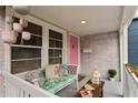 Inviting front porch with comfortable seating and pink accents, creating a cozy and stylish entrance at 4012 N Munro St, Tampa, FL 33603