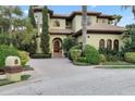 Beautiful two-story home featuring a circular driveway and lush, mature landscaping at 4128 Causeway Vista Dr, Tampa, FL 33615