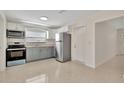 Well-lit kitchen with stainless steel appliances, ample cabinet space, and a clean, functional layout at 4714 W Vasconia St, Tampa, FL 33629