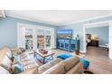 Comfortable living room with a TV and balcony doors overlooking scenic water views at 4900 Brittany S Dr # 611, St Petersburg, FL 33715