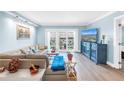 Bright and airy living room featuring stylish furniture, hardwood floors, and balcony access with water views at 4900 Brittany S Dr # 611, St Petersburg, FL 33715