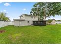 Spacious backyard featuring lush green grass and a screened-in porch at 4918 Stolls Ave, Tampa, FL 33615