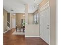 Inviting foyer featuring wood-look floors, neutral walls, a dining area, and natural light at 589 52Nd N Ave, St Petersburg, FL 33703