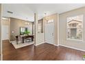 Inviting foyer featuring wood-look floors, neutral walls, a dining area, and natural light at 589 52Nd N Ave, St Petersburg, FL 33703
