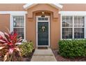 Charming front door entrance flanked by two windows and decorative landscaping on either side at 589 52Nd N Ave, St Petersburg, FL 33703