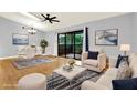 Living room with ample seating, hardwood floors, dining area, and natural light from balcony at 6361 92Nd N Pl # 1704, Pinellas Park, FL 33782