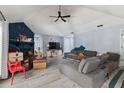 Inviting living room featuring wood-look flooring, a fireplace, and a ceiling fan at 6645 Freeport Dr, Spring Hill, FL 34608