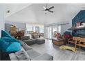 Cozy living room with vaulted ceilings, wood-look flooring, and a unique fireplace at 6645 Freeport Dr, Spring Hill, FL 34608