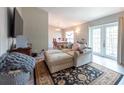 Cozy living room with a large comfy couch, rug, and sliding glass doors to the backyard at 6817 S Gabrielle St, Tampa, FL 33611