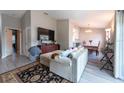 Spacious living room offering hardwood floors and an open layout into the dining and kitchen areas at 6817 S Gabrielle St, Tampa, FL 33611