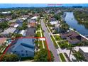 This home features an aerial view of a waterfront community with beautiful palm trees and lush landscaping at 7114 Pelican Island Dr, Tampa, FL 33634