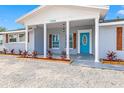 Beautifully updated home with a bright blue front door and quaint front porch at 7804 Bracken Dr, Port Richey, FL 34668