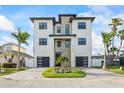 Beautiful modern home with a stone accent wall, dual garage and a well landscaped circular driveway at 820 Bay Point Dr, Madeira Beach, FL 33708