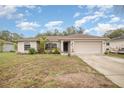 Charming single-story home with a two-car garage and lovely landscaping creating curb appeal at 2816 Soprano Ln, North Port, FL 34286