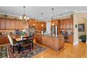 Spacious kitchen featuring wooden cabinetry, granite countertops, a large island, and stainless-steel appliances at 3118 W Bay Villa Ave, Tampa, FL 33611