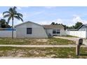 View of a single-story home with a palm tree in a well-maintained lawn at 1009 Sagamore Dr, Seffner, FL 33584