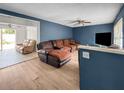 Cozy living room with blue walls, a ceiling fan, and hardwood floors at 1009 Sagamore Dr, Seffner, FL 33584