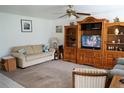 Inviting living room with plush sofa, classic wooden furniture, and a cozy ambiance enhanced by soft lighting at 101 Cambridge Trl # 205, Sun City Center, FL 33573