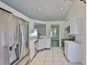 Bright kitchen with stainless steel appliances, white cabinets, and white countertops at 10414 Hallmark Blvd, Riverview, FL 33578
