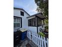 Home exterior featuring black trimmed and white picket fence at 1107 Grant St, Clearwater, FL 33755