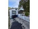 White home with a black trimmed and a driveway at 1107 Grant St, Clearwater, FL 33755