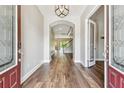 Welcoming foyer with hardwood floors and an open view of the staircase at 11407 Drifting Leaf Dr, Riverview, FL 33579