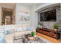 Comfortable living room showcasing a stone accent wall, plush sofa, and stylish decor at 11623 Greensleeve Ave, Tampa, FL 33626