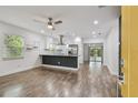 Open concept living space featuring updated kitchen, wood floors, recessed lighting and access to the lanai at 1311 W Perdiz St, Tampa, FL 33612