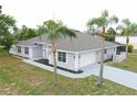 Lovely single-story home boasts a two-car garage and meticulous landscaping with vibrant palm trees at 13551 Banner Rd, Spring Hill, FL 34609