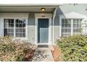 Inviting front entrance with well-manicured shrubs and windows at 2248 Lake Woodberry Cir, Brandon, FL 33510