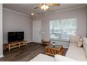 Comfortable living area with neutral tones, laminate flooring, and plenty of natural light at 2316 Lake Woodberry Cir, Brandon, FL 33510