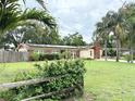 Beautiful Florida ranch-style home with solar panels, large landscaped yard and mature palm trees at 2523 Krueger Lane, Tampa, FL 33618