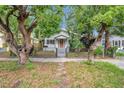 Traditional home with chain link fence and mature trees in the front yard provide natural shade at 2808 N Highland Ave, Tampa, FL 33602
