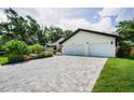 Spacious driveway leading to a well-maintained home with a two-car garage and manicured landscaping at 3089 Ashland Ter, Clearwater, FL 33761