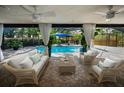 Inviting covered patio overlooking a screened pool, featuring comfortable seating and stylish decor at 3089 Ashland Ter, Clearwater, FL 33761