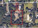 Estate aerial view showing property lines, lush greenery, and a barn with horse pastures at 309 Hidden Lake Dr, Brandon, FL 33511