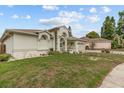 Side view of home with manicured lawn and clean landscaping surrounding the house at 3138 Deergrass Ct, Holiday, FL 34691