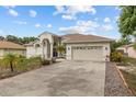 A bright home with a large driveway and well-maintained landscaping at 3138 Deergrass Ct, Holiday, FL 34691