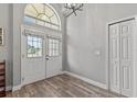 Bright foyer with tall ceilings, laminate flooring, natural light, and a double door entrance at 3138 Deergrass Ct, Holiday, FL 34691