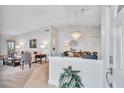 Elegant living room featuring a crystal chandelier, neutral tones, and open layout at 3271 Mcmath Dr, Palm Harbor, FL 34684