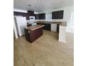 Features an island, white appliances, and dark cabinetry at 3713 N 31St St, Tampa, FL 33610