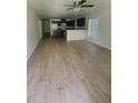 Open-concept living space with wood-look flooring at 3713 N 31St St, Tampa, FL 33610