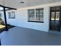 Spacious front porch features fresh paint, creating an inviting outdoor living space at 3844 Cedarwood Dr, Holiday, FL 34691