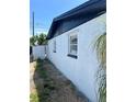 View of the side of the house showing a clean, freshly painted exterior and neat yard space at 3844 Cedarwood Dr, Holiday, FL 34691