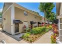 Exterior of a condo showcasing manicured landscaping, awnings, and a neatly maintained pathway for enhanced curb appeal at 409 S Audubon Ave # 3, Tampa, FL 33609
