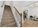 Bright staircase with wood and iron railing leading to an open-concept dining area and kitchen at 409 S Audubon Ave # 3, Tampa, FL 33609