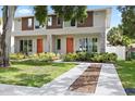 Charming front exterior showcasing a walkway, vibrant orange doors, and a lush green lawn at 4206 W North B St # 2, Tampa, FL 33609